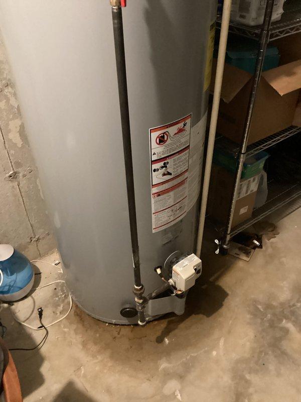 Responded to service call for water heater evaluation due to reported small leak in basement. Upon inspection, assessed residential water heater installation including all associated copper piping, gas control valve connections, and pressure relief valve system. Documented existing equipment conditions through photographic records showing complete water heater assembly, connected plumbing infrastructure, and surrounding utility room components including water filtration system. Provided comprehensive estimate for necessary repairs or replacement options to address identified leak condition.