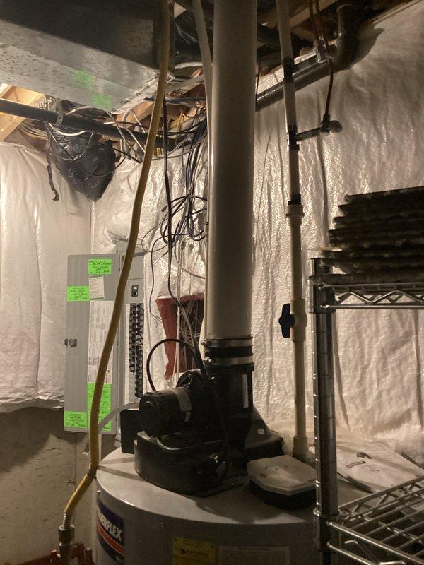 Responded to service call for water heater evaluation due to reported small leak in basement. Upon inspection, assessed residential water heater installation including all associated copper piping, gas control valve connections, and pressure relief valve system. Documented existing equipment conditions through photographic records showing complete water heater assembly, connected plumbing infrastructure, and surrounding utility room components including water filtration system. Provided comprehensive estimate for necessary repairs or replacement options to address identified leak condition.
