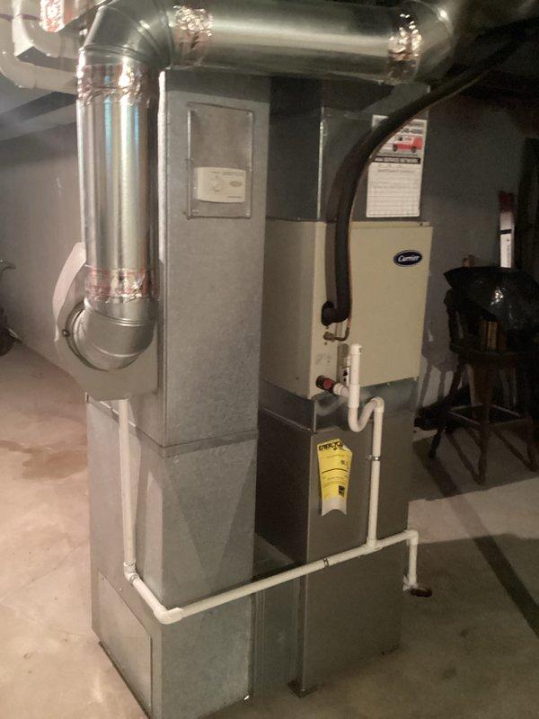 Completed estimate for full HVAC system replacement at residential property with non-operational air conditioning unit and aging furnace equipment located in basement. Assessed existing Carrier furnace with attached humidifier unit, ductwork configuration, and exterior condensing unit to provide replacement options for complete heating and cooling system.