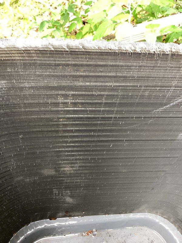 Responded to service call for non-operational air conditioning unit with reported pink fluid leak. Upon inspection, identified contaminated condensate drain system causing colored discharge. Cleaned condenser coil fins, cleared drain line obstruction, verified compressor operation, tested capacitor functionality, and confirmed system returned to normal cooling operation with proper drainage.
