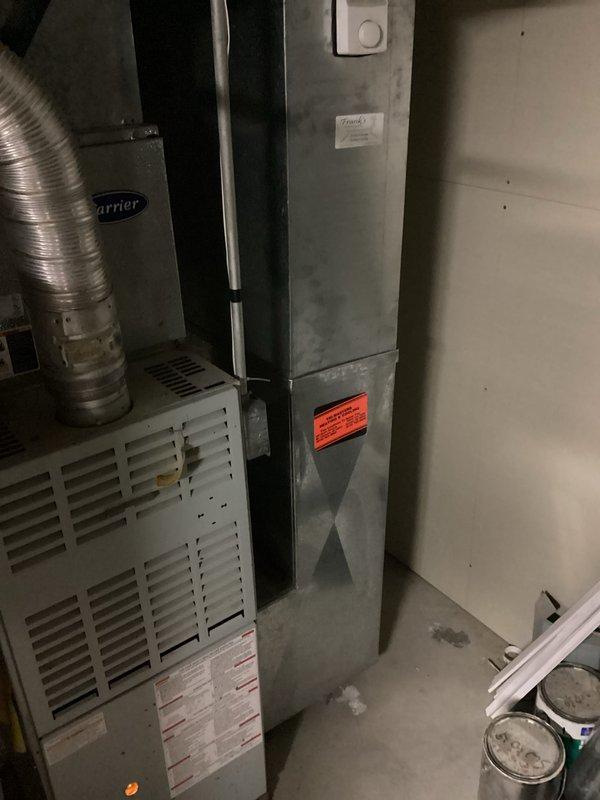 Provided estimate for complete HVAC system replacement of aging 1996 equipment, including outdoor condensing unit positioned on exterior concrete pad and indoor Carrier furnace with vertical plenum assembly located in basement utility area. Assessed existing natural gas furnace configuration, ductwork connections, and current system layout to recommend appropriate replacement equipment sizing and specifications for improved efficiency and reliability.