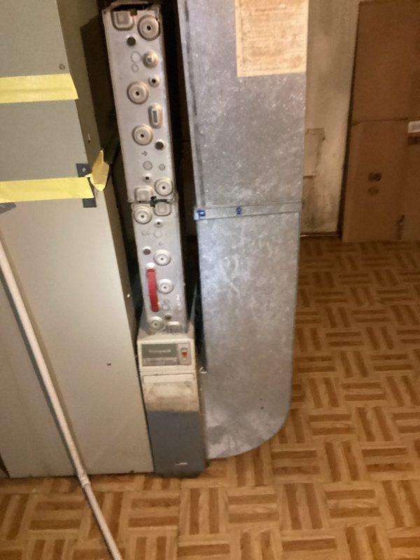 Conducted comprehensive assessment of 30-year-old air conditioning and furnace system located in basement. The existing air conditioner was non-operational and both units had reached end of useful service life. Performed thorough evaluation of current equipment, ductwork, and mechanical infrastructure. Documented existing system configuration including condensate drainage concerns evidenced by moisture accumulation on ductwork components and water staining on basement walls. Photographed mechanical panel with multiple connection points, gauges, and control elements to assess current system layout. Provided detailed replacement estimate for new air conditioning unit and furnace system to restore full HVAC functionality to the residence.