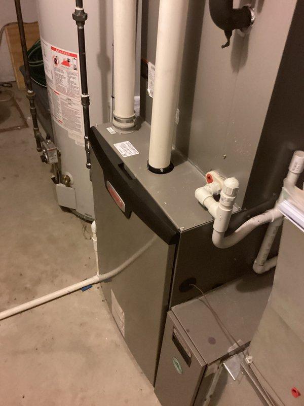 Responded to AC system with no refrigerant charge. Upon inspection, found evaporator coil failing and system completely empty. Recharged system and documented outdoor condenser unit and indoor furnace/air handler installation. Customer advised of evaporator coil condition requiring replacement within 3-5 years.