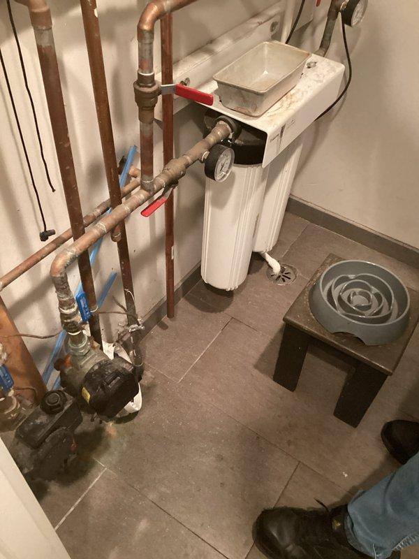 Responded to service call for tankless water heater with internal valve leak. Upon inspection, identified leaking internal valve requiring replacement and provided estimate for repair. Documented existing installation including ventilation system, plumbing connections, and associated water treatment equipment for customer records.
