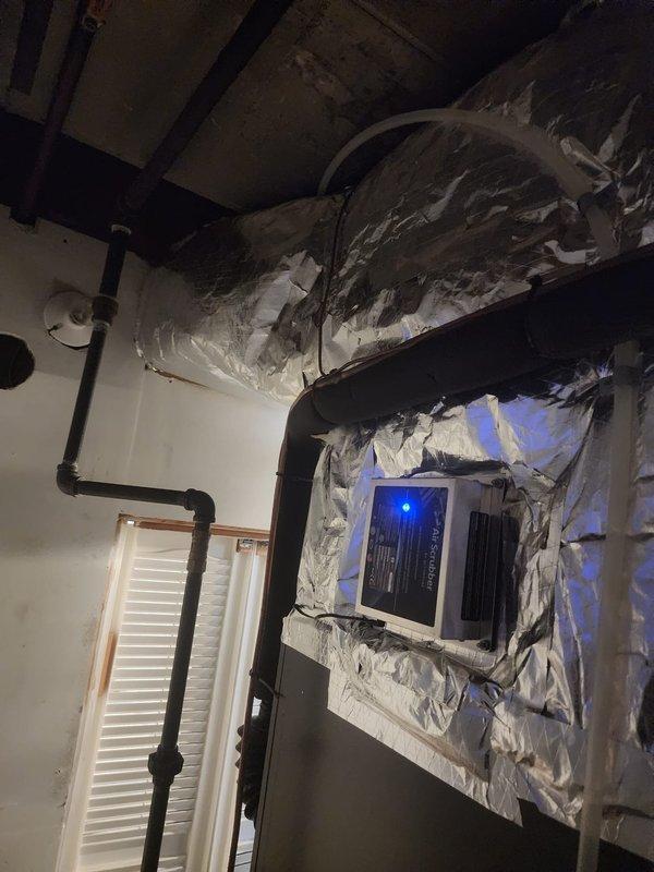 Insulated plenum assembly in mechanical space to improve system efficiency and prevent condensation issues. Applied foil-faced insulation wrap to exposed ductwork and plenum connections, securing all materials with proper fasteners and ensuring complete coverage around HVAC distribution components. Verified all insulation seams were properly sealed and that clearances were maintained around existing PVC piping, water heater, and electrical components in the confined space.