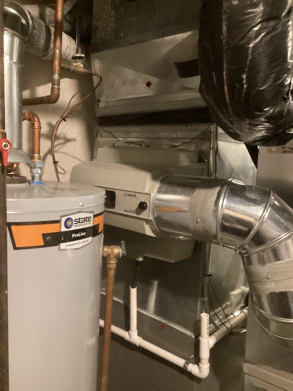 Completed air conditioning replacement estimate for residential HVAC system. Documented existing equipment configuration including furnace/air handler unit, ductwork layout, and associated components to provide replacement options excluding Lennox brand per customer preference.