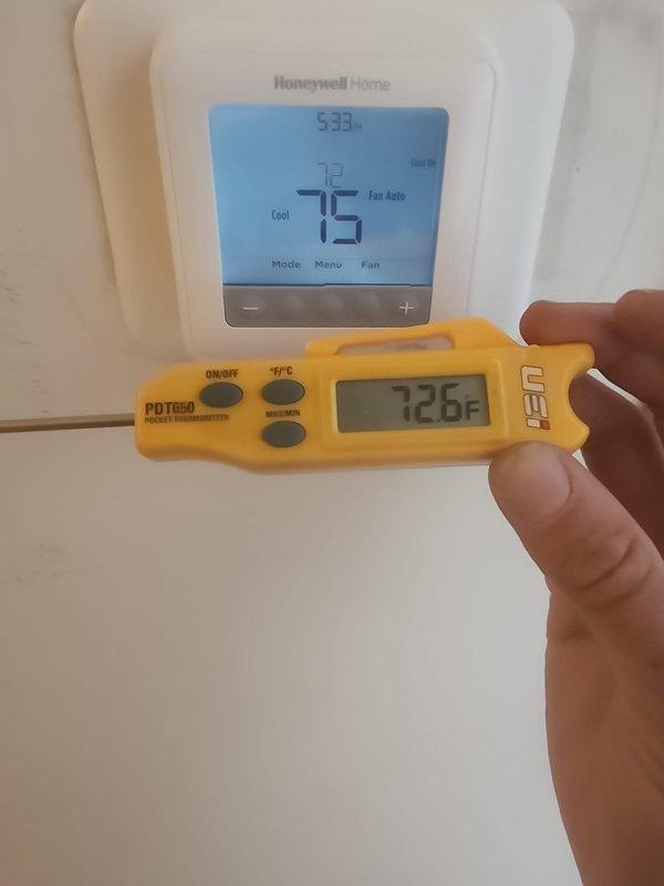 Responded to no cooling callback after recent thermostat replacement. Upon arrival, verified Honeywell Home TH6210U2001 thermostat installation and confirmed unit operational with 2.2°F temperature differential between thermostat reading (75°F) and handheld thermometer measurement (72.8°F), which is within normal calibration tolerance. Documented thermostat model information and battery installation, system cycling properly in cooling mode.