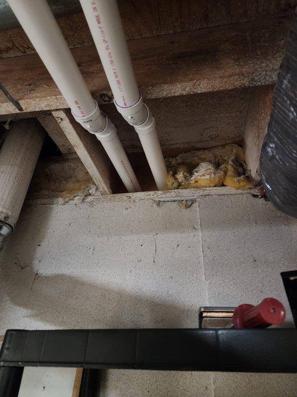Installed a 50-gallon Bradford White natural draft water heater in basement utility area. Connected copper supply lines with shut-off valves, installed blue expansion tank on wall mount, and configured proper venting through existing ductwork to ensure safe exhaust operation.