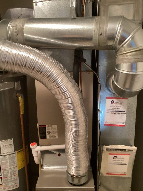 Provided comprehensive estimate for complete air conditioning system replacement on 20-year-old unit currently in operational condition. Evaluated existing indoor air handler located in basement utility area with associated ductwork infrastructure and outdoor condenser units positioned on exterior mulched pad adjacent to building foundation. Assessment included documentation of dual outdoor condensers, flexible and rigid ductwork configurations, refrigerant line routing, and electrical connections to determine optimal replacement specifications and installation requirements.