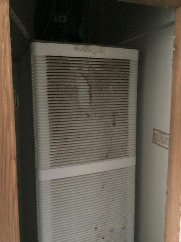 Conducted estimate for complete HVAC system replacement of non-operational air conditioning unit and aging furnace located in interior utility closet. Existing equipment showed significant age with dust accumulation on ventilation grilles and components, requiring full system replacement. Assessed confined installation space with wall-mounted air handler, evaluated existing ductwork configuration including flexible aluminum ducting, and documented current system layout for proper equipment sizing and replacement specifications.