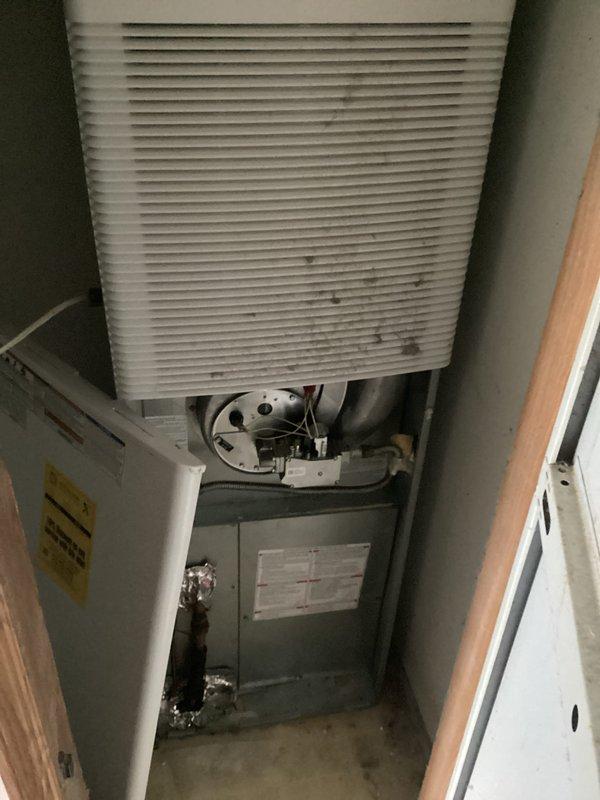 Conducted estimate for complete HVAC system replacement of non-operational air conditioning unit and aging furnace located in interior utility closet. Existing equipment showed significant age with dust accumulation on ventilation grilles and components, requiring full system replacement. Assessed confined installation space with wall-mounted air handler, evaluated existing ductwork configuration including flexible aluminum ducting, and documented current system layout for proper equipment sizing and replacement specifications.