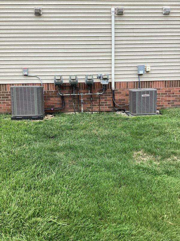Responded to callback regarding AC disconnect installation concerns. Relocated electrical disconnect box to original mounting position to cover faded area on exterior wall. Rerouted high voltage wiring to enter through back of disconnect box instead of side entry for proper installation compliance. Applied appropriate labeling to disconnect per code requirements. Installation now meets standard specifications with improved aesthetics and proper wiring configuration.