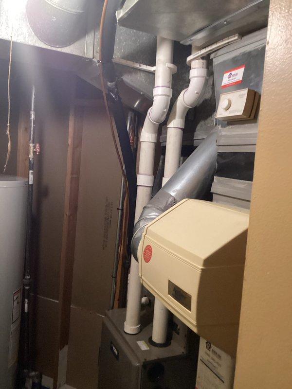 Completed HVAC replacement estimate for residential system. Evaluated existing equipment configuration including air handler unit in attic space, water heater, and humidifier system in mechanical room. Documented current installation with PVC venting, ductwork connections, and equipment layout to provide comprehensive replacement recommendations.