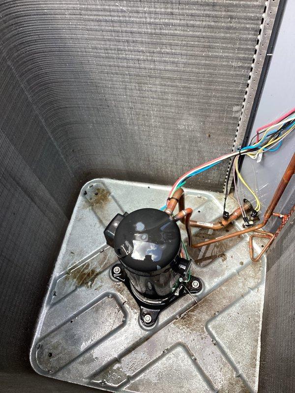 Responded to callback for non-operational air conditioning system. Upon arrival, performed visual inspection of outdoor condensing unit and internal components. Found unit with dirty condenser coil showing significant debris accumulation and weathering on exterior fins. Opened unit to inspect compressor, refrigerant lines, and electrical connections. All copper refrigerant lines showed normal oxidation consistent with age, with no visible leaks detected. Compressor appeared operational with secure mounting and intact electrical connections. Documented current condition of equipment with photographs for service records.
