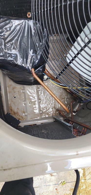 Completed comprehensive AC maintenance inspection on outdoor condensing unit. Performed visual assessment of evaporator coil assembly, noting intact metallic fins and proper copper refrigerant line connections. Inspected condenser unit exterior, confirmed operational grille assembly and manufacturer specifications visible. Documented minor debris accumulation around base pad and exterior housing, consistent with normal outdoor installation conditions. Unit showing typical weathering with functional components intact. All system elements photographed for maintenance records.