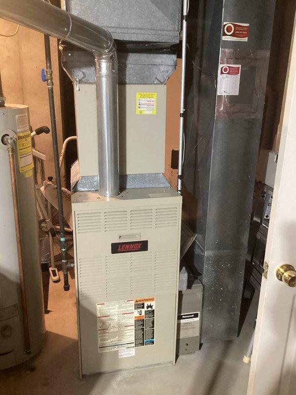 Provided comprehensive estimate for replacement of 32-year-old Lennox furnace and hot water heater located in basement utility room. Current natural gas furnace remains operational but has exceeded typical service life. Evaluated existing ductwork configuration, plenum connections, and utility room layout to determine optimal replacement specifications and installation requirements for both heating system and water heater upgrade.