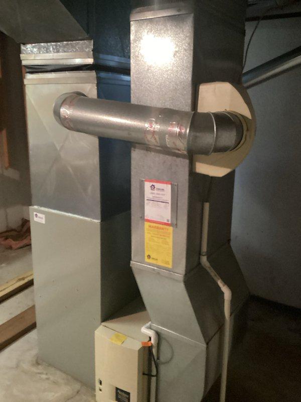 Conducted air conditioning replacement estimate for residential HVAC system. Upon initial visit, existing furnace and air handler configuration was assessed in basement mechanical room, including ductwork connections, electrical supply, and current equipment condition. Customer reported unit failure immediately following the initial estimate appointment. Documented existing equipment installation with metallic supply ductwork, plenum connections, and current system layout. Photographed furnace cabinet with EnergyGuide label, vertical piping, and electrical conduit routing for replacement planning purposes. System evaluation completed to determine proper replacement unit sizing and compatibility with existing ductwork infrastructure. Follow-up service appointment scheduled to address reported equipment failure and finalize replacement specifications.