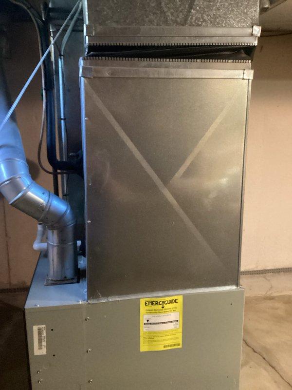 Conducted air conditioning replacement estimate for residential HVAC system. Upon initial visit, existing furnace and air handler configuration was assessed in basement mechanical room, including ductwork connections, electrical supply, and current equipment condition. Customer reported unit failure immediately following the initial estimate appointment. Documented existing equipment installation with metallic supply ductwork, plenum connections, and current system layout. Photographed furnace cabinet with EnergyGuide label, vertical piping, and electrical conduit routing for replacement planning purposes. System evaluation completed to determine proper replacement unit sizing and compatibility with existing ductwork infrastructure. Follow-up service appointment scheduled to address reported equipment failure and finalize replacement specifications.