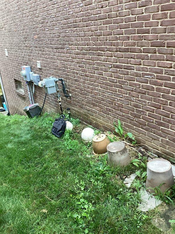 Conducted comprehensive site evaluation for standby generator installation at residential property. Assessed existing electrical infrastructure, including current HVAC equipment and utility connections along exterior brick wall. Documented installation location requirements, clearance specifications from building structures, and optimal positioning for generator pad placement on lawn area adjacent to existing concrete utility bases. Evaluated accessibility for fuel line routing, transfer switch installation requirements, and compliance with manufacturer clearance specifications for proper ventilation and service access.