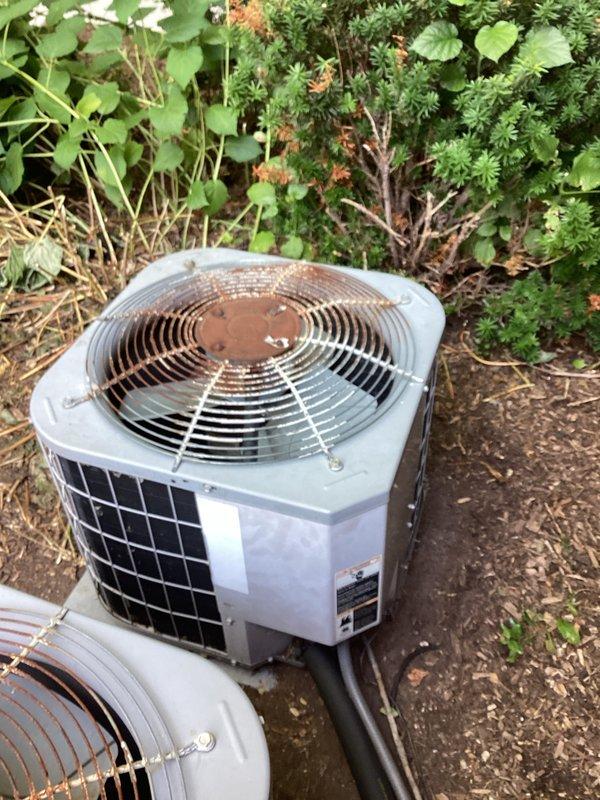 Responded to service call for non-operational air conditioning system at end unit condominium. Upon arrival, evaluated 20-year-old outdoor condenser unit located at rear of property. Conducted thorough visual inspection of existing equipment, documenting current system condition through photographic documentation. Assessed condenser unit positioning, clearances, and surrounding landscape conditions. Evaluated interior mechanical space housing water heater and utility connections to determine compatibility requirements for replacement system installation. Provided comprehensive replacement estimate for complete HVAC system upgrade. Confirmed all site information and documentation with property owner via text communication.