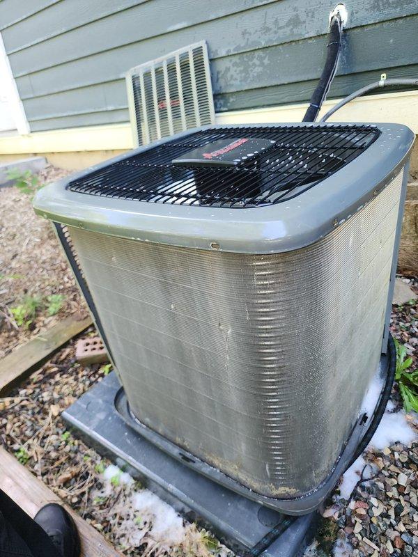 Completed preventive maintenance service on two residential cooling systems. Upon inspection of one unit, discovered ice formation on compressor dome with unusual discoloration, indicating potential refrigerant issue or restriction in the system requiring further diagnosis. Documented equipment conditions with photos for service records. Both outdoor condensing units inspected for proper operation, electrical connections, and overall system performance per maintenance agreement protocols.