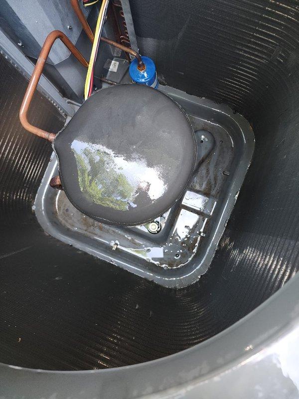 Completed preventive maintenance service on two residential cooling systems. Upon inspection of one unit, discovered ice formation on compressor dome with unusual discoloration, indicating potential refrigerant issue or restriction in the system requiring further diagnosis. Documented equipment conditions with photos for service records. Both outdoor condensing units inspected for proper operation, electrical connections, and overall system performance per maintenance agreement protocols.