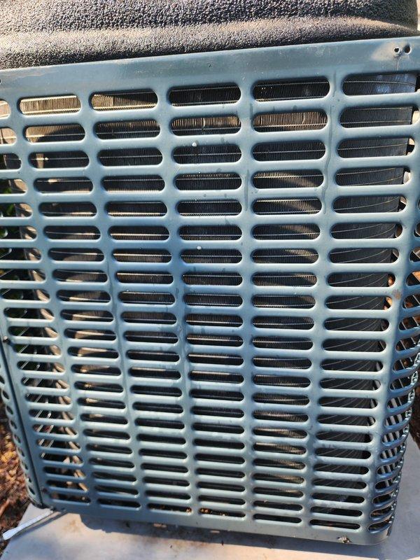 Completed preventive maintenance inspection on residential split-system air conditioning unit. Performed visual examination of outdoor condensing unit, confirming proper condition of protective grille, condenser coil fins, compressor assembly, and refrigerant line connections. All major components including compressor, condenser coils, and electrical connections were inspected and found to be in satisfactory operating condition with no immediate service needs identified.
