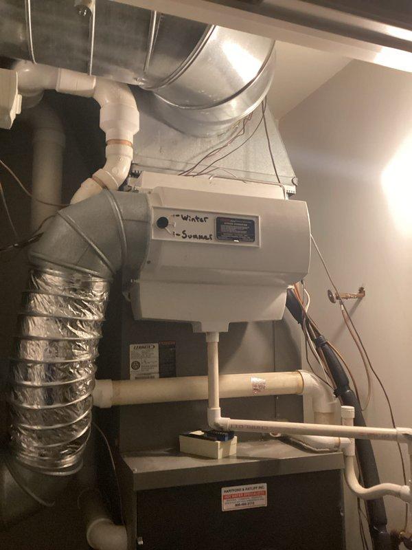 Completed comprehensive HVAC replacement estimate for dual-system residential installation. Both air conditioning units, over 20 years old, were found to be non-operational with leaking evaporator coils. Assessed existing furnace and air handler configurations in utility spaces, documented current ductwork connections including flexible metallic ducting and rigid supply lines, and evaluated associated PVC condensate drainage systems. Photographed existing equipment installations to provide detailed documentation for replacement specifications and equipment sizing requirements.