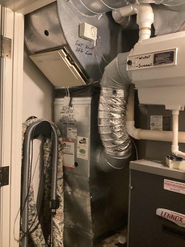 Completed comprehensive HVAC replacement estimate for dual-system residential installation. Both air conditioning units, over 20 years old, were found to be non-operational with leaking evaporator coils. Assessed existing furnace and air handler configurations in utility spaces, documented current ductwork connections including flexible metallic ducting and rigid supply lines, and evaluated associated PVC condensate drainage systems. Photographed existing equipment installations to provide detailed documentation for replacement specifications and equipment sizing requirements.
