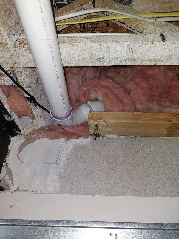 Responded to no hot water call. Upon arrival, accessed attic space to inspect tanked water heater installation. Found water heater system with associated plumbing connections including PVC piping for condensate drainage and water supply lines. Inspected installation including mounting, insulation placement around framing members, and proper venting configuration. Verified all pipe connections, supports, and hangers were secure and properly installed per code requirements. System operational upon completion of inspection and service.