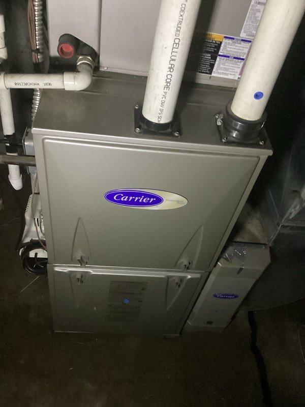 Completed replacement estimate for 15-year-old Carrier HVAC system with failed blower motor. Assessed existing furnace installation in basement utility space, including auxiliary components, refrigerant lines, PVC condensate drainage system, and flexible ductwork connections. Documented current equipment configuration and provided replacement recommendations; advised to cancel scheduled maintenance appointment if customer proceeds with system replacement.
