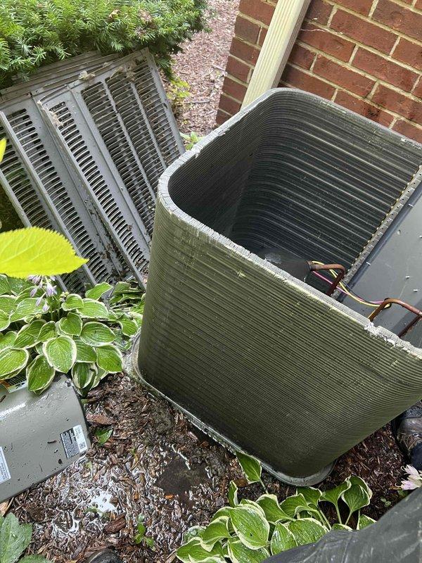 Responded to service call for inadequate cooling in 3-level townhouse with HVAC system located on bottom level. Customer reported AC running continuously, unable to maintain temperature below 80°F on middle floor and 88°F on upper level, while bottom level cooled adequately. Inspected outdoor condenser unit and found heavily soiled condenser coils with significant dirt and debris buildup restricting airflow. Coils showed dark discoloration and accumulated grime throughout exterior surfaces. Cleaned condenser coils thoroughly to restore proper heat transfer efficiency and airflow capacity. Verified compressor operation and refrigerant line connections. Recommended evaluation of ductwork design and airflow balance throughout multi-level system to address temperature stratification issues, as inadequate air distribution may be contributing to poor upper-level cooling performance.
