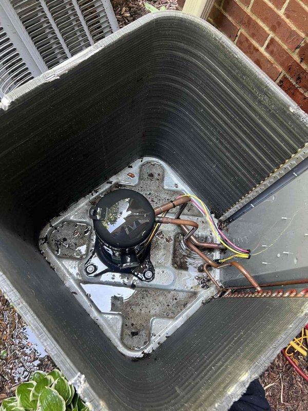 Responded to service call for inadequate cooling in 3-level townhouse with HVAC system located on bottom level. Customer reported AC running continuously, unable to maintain temperature below 80°F on middle floor and 88°F on upper level, while bottom level cooled adequately. Inspected outdoor condenser unit and found heavily soiled condenser coils with significant dirt and debris buildup restricting airflow. Coils showed dark discoloration and accumulated grime throughout exterior surfaces. Cleaned condenser coils thoroughly to restore proper heat transfer efficiency and airflow capacity. Verified compressor operation and refrigerant line connections. Recommended evaluation of ductwork design and airflow balance throughout multi-level system to address temperature stratification issues, as inadequate air distribution may be contributing to poor upper-level cooling performance.
