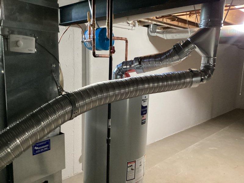 Successfully installed a new 50-gallon tanked water heater in the basement utility area. The installation included proper venting with flexible aluminum ductwork connected to the existing rigid vent system, copper supply line connections with soldered joints, and appropriate positioning adjacent to the existing HVAC equipment. All connections were completed to code specifications, the unit was tested for proper operation, and the installation area was left clean and ready for use.