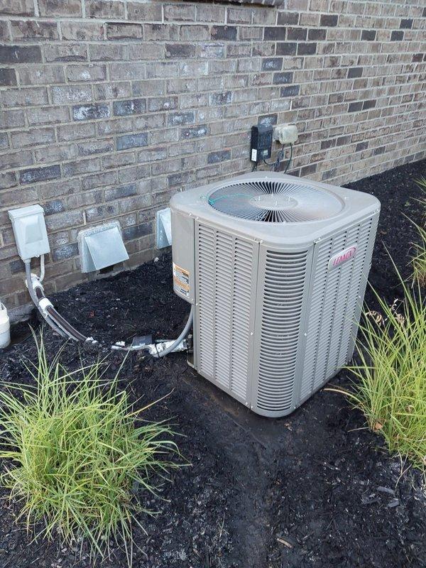 Responded to no cooling complaint on 7-year-old Lennox air conditioning system located at exterior of residence. Upon arrival, performed diagnostic inspection of outdoor condensing unit positioned against brick wall in mulch bed. Verified unit power supply at electrical disconnect box and checked all electrical connections. Evaluated condenser operation, refrigerant levels, and overall system performance to identify cause of cooling failure and restore proper air conditioning function.