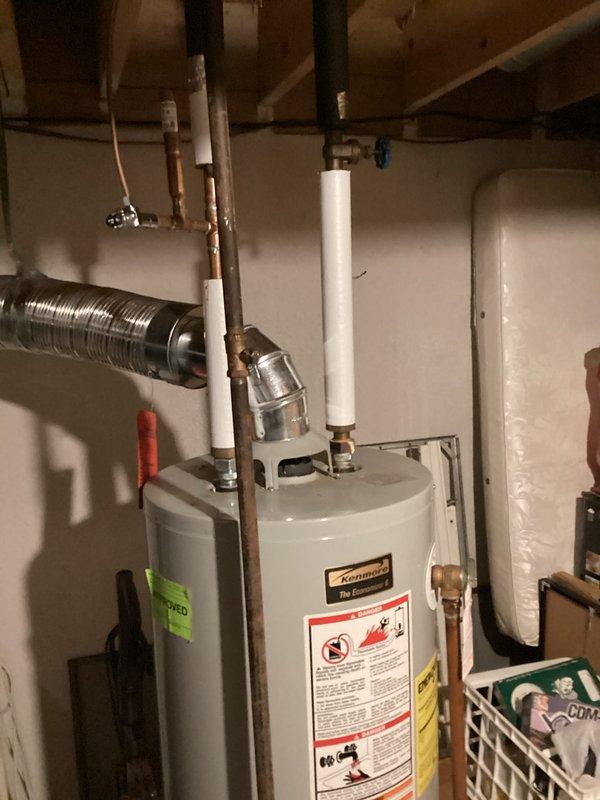 Conducted comprehensive assessment of existing residential water heater installation in basement utility area for replacement estimate. Evaluated current unit specifications, plumbing connections including copper supply lines with brass fittings and shut-off valves, PVC venting configuration, and clearance requirements for new equipment installation. Documented existing system configuration with photographs showing current water heater condition, piping layout, and surrounding mechanical room space to provide accurate replacement proposal. Coordinated visit with scheduled air conditioning maintenance service for customer convenience.
