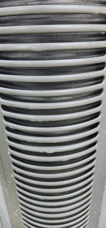 Completed routine cooling season maintenance on residential air conditioning system. Removed outdoor condenser unit access panel and performed comprehensive inspection of all major components. Inspected compressor assembly, refrigerant lines, and electrical connections; all found to be in proper working condition with secure wire terminations. Examined condenser coil and noted minor dirt and debris accumulation between fins. Inspected indoor evaporator coil assembly, which showed clean fins and intact serpentine tubing with no signs of corrosion or damage. All components operating within normal parameters. System ready for cooling season operation.