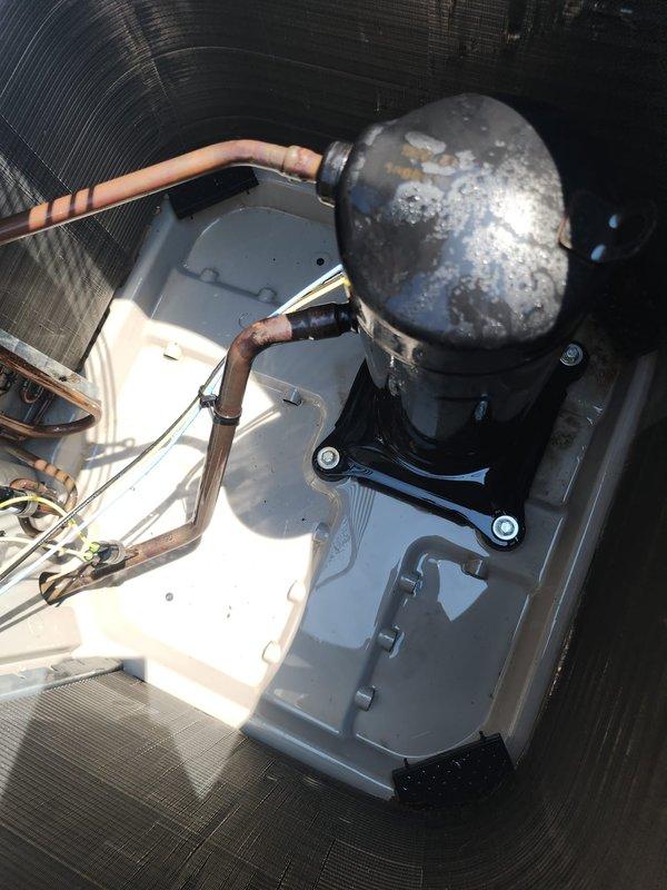 Completed comprehensive AC tune-up on 2018 residential air conditioning system with outdoor unit located in backyard. Performed standard preventative maintenance procedures including inspection of compressor unit showing weathering and surface oxidation consistent with age, verified refrigerant line connections and insulation integrity, examined condenser coil fins noting some discoloration in upper section, and documented equipment condition through photography. System operational with no immediate concerns identified during routine maintenance visit.