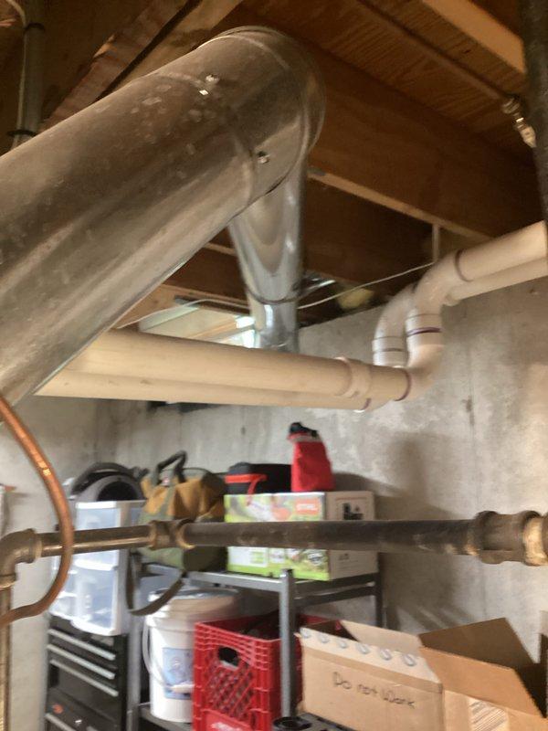 Completed on-site assessment for water heater replacement in basement utility area. Evaluated existing white cylindrical water heater, associated copper supply and distribution piping, venting requirements, and clearances relative to HVAC ductwork and electrical systems. Documented current installation configuration including vertical copper pipe routing, ceiling-mounted support systems, and proximity to mechanical equipment. Provided estimate for replacement unit installation scheduled for May 7th, with availability for earlier completion if required.