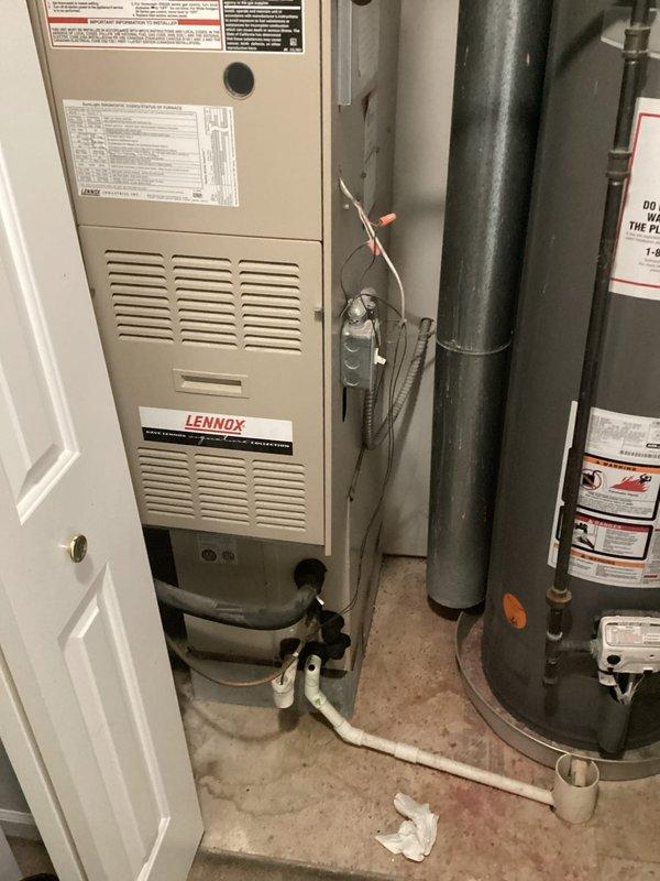 Completed HVAC replacement estimate for residential system. Confirmed account information via text communication and documented existing Lennox furnace installation and water heater configuration in basement mechanical room with photographic records for proposal preparation.