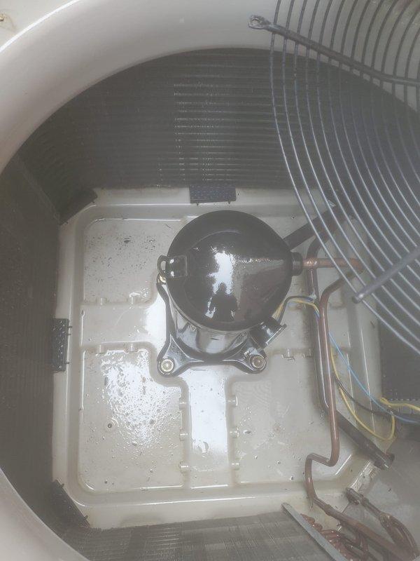 Completed annual air conditioning maintenance and tune-up on residential split system with outdoor condensing unit and basement-mounted A-coil and furnace. Performed comprehensive inspection of compressor, refrigerant lines, and condenser coil, verified proper airflow through protective grille, and checked all mechanical components for optimal operation. System found to be in good working condition with no issues identified or repairs required.