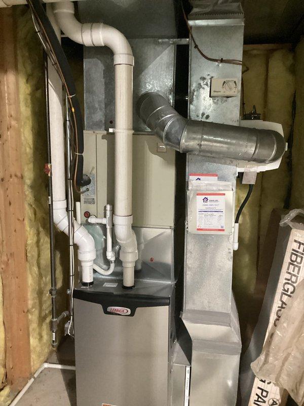 Completed comprehensive HVAC system replacement estimate for residential property. Assessed existing outdoor condensing unit showing weathering and vegetation overgrowth, along with interior Lennox furnace installation in unfinished basement space with associated ductwork, PVC venting, and refrigerant lines. Documented current system configuration including electrical infrastructure, Generac components, and overall equipment condition to provide replacement recommendations.