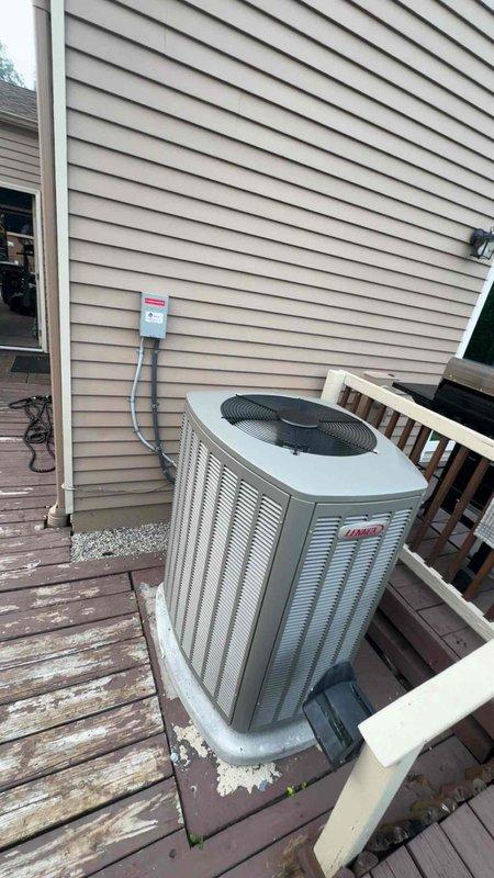Completed full HVAC system replacement including installation of Lennox high-efficiency furnace in mechanical room with proper venting using white PVC exhaust and intake piping extending vertically through structure. Installed new Lennox air conditioning condenser unit on existing wooden deck platform with electrical disconnect box mounted to exterior siding and appropriate conduit runs. Connected gas line with shutoff valve, condensate drainage system, and all necessary ductwork transitions using flexible boot connectors. Mounted and programmed Lennox S40 smart thermostat for system control and installed Air Scrubber air purification system integrated with HVAC equipment. Verified all electrical connections, tested system operation for heating and cooling modes, confirmed proper airflow, and ensured all safety controls functioning correctly. All installations meet manufacturer specifications and local code requirements with system fully operational upon completion.
