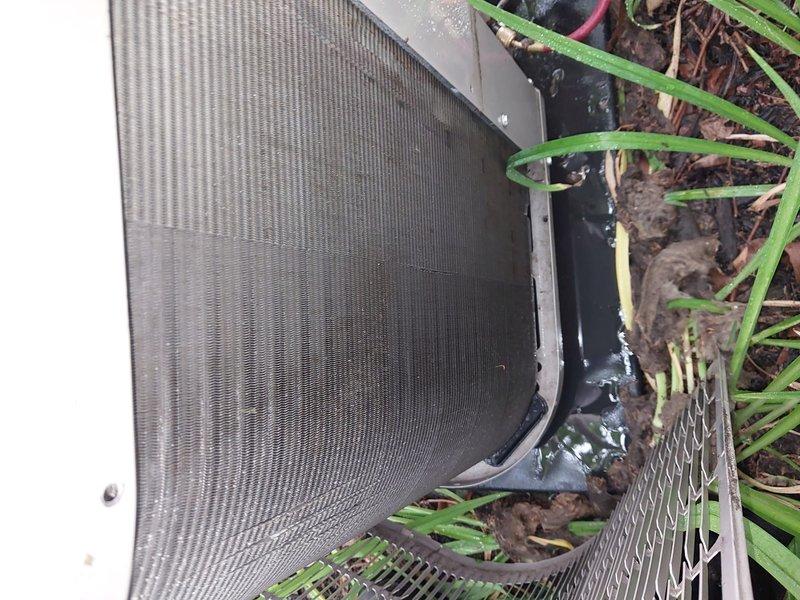 Responded to service call for 4-year-old air conditioning system located in basement laundry room requiring maintenance tune-up. Performed comprehensive system inspection of outdoor condenser unit and components. Inspected condenser coils, fan motor assembly, and electrical connections. Cleaned condenser coils and removed debris from unit exterior and surrounding area. Verified fan operation and checked refrigerant lines for proper insulation and connections. Conducted visual assessment of unit mounting platform and clearance requirements. System evaluated for operational efficiency and cooling performance. All components found to be functioning within normal parameters following tune-up service.