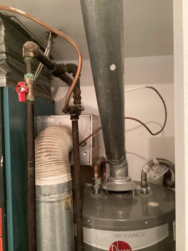 Conducted comprehensive evaluation of 24+ year old non-operational air conditioning system and existing furnace for complete HVAC replacement estimate. Assessed outdoor condensing unit mounted on deteriorated concrete pad with aged electrical disconnects, inspected indoor mechanical room housing furnace and water heater with existing ductwork and plumbing connections. Documented equipment conditions, existing infrastructure, and spatial requirements to provide accurate replacement system specifications for both cooling and heating equipment.