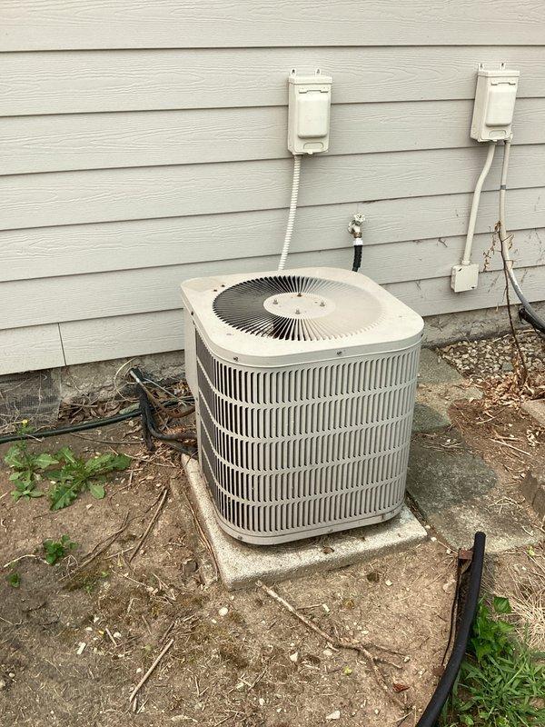 Conducted comprehensive evaluation of 24+ year old non-operational air conditioning system and existing furnace for complete HVAC replacement estimate. Assessed outdoor condensing unit mounted on deteriorated concrete pad with aged electrical disconnects, inspected indoor mechanical room housing furnace and water heater with existing ductwork and plumbing connections. Documented equipment conditions, existing infrastructure, and spatial requirements to provide accurate replacement system specifications for both cooling and heating equipment.