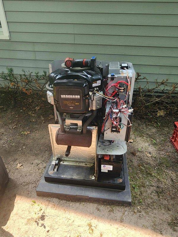 # Generator and Air Conditioning Maintenance Service

Performed comprehensive maintenance on residential standby generator equipped with Vanguard 627cc gasoline engine. Conducted visual inspection of electrical control panel, verified wiring connections, and assessed overall system integrity. Generator unit mounted on concrete pad with wooden platform base showed normal operational condition.

Completed maintenance service on outdoor split-system air conditioning unit located adjacent to generator. Upon inspection, discovered significant accumulation of dried grass, hay, and organic debris lodged within internal components between compressor and cabinet sections. Removed all foreign material obstructing airflow and mechanical components to restore proper system function and prevent potential fire hazard or equipment damage. Cleared debris from concrete pad and surrounding area.

Inspected compressor housing, fan assembly, and electrical connections on both systems. Verified proper clea