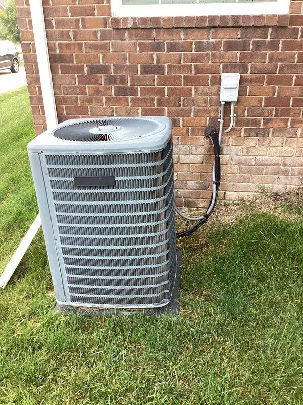 Completed air conditioning replacement estimate for residential property. Evaluated existing outdoor condenser unit positioned on grade-level pad adjacent to brick exterior wall with electrical disconnect box and conduit properly mounted. Assessed current system configuration, electrical connections, and refrigerant line routing to provide comprehensive replacement options for 8-10 ton cooling capacity system. Customer requested Saturday appointment scheduling for installation upon estimate approval, and account information was verified for processing.