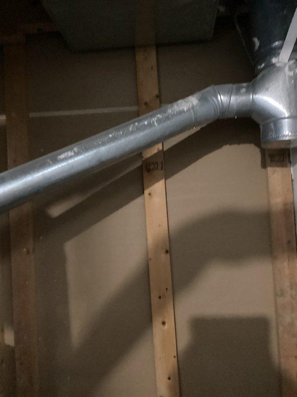 Completed water heater estimate for Bradford White Defender Safety System unit located in unfinished basement utility area. Inspected existing installation including copper and galvanized piping connections, brass valve assembly, and exhaust vent ductwork. Documented current water heater configuration with cold water inlet, hot water outlet, and HVAC duct routing through overhead joists. Account information verified and photographic documentation captured for estimate preparation.