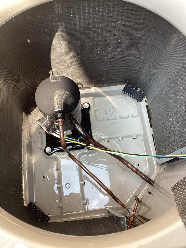 Responded to service call for A/C system blowing warm air during afternoon hours. Upon inspection, found Bryant condensing unit operational with proper airflow through exterior grille. Examined indoor evaporator coil assembly and associated components including refrigerant lines, electrical connections, and safety devices. Verified all copper line connections secure, electrical wiring properly terminated, and float switch functioning correctly. System restored to normal cooling operation with no further issues detected.